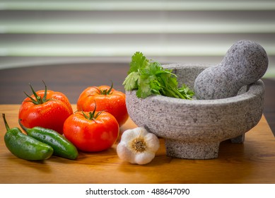 Zesty salsa with tomato and peppers, pico de gallo molcajete (mortar) and tejolete (pestle)