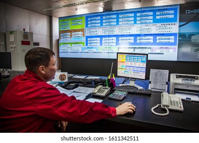 Zhanazhol, Aktobe region, Kazakhstan - May 04 2012: Oil refinery plant. Operation control room (center). Operator in red work wear monitoring processes. CNPC company - Shutterstock ID 1611342511