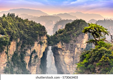 Zhangjiajie Forest Park At Sunrise. Natural Bridge Connecting Two Mountain Columns.