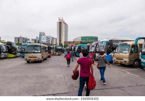 Zhangjiajie,China-September 18, 2019: Travel\
agencies bus parking in a touristic area waiting tourist in\
Zhangjiajie National Park, Hunan\
China