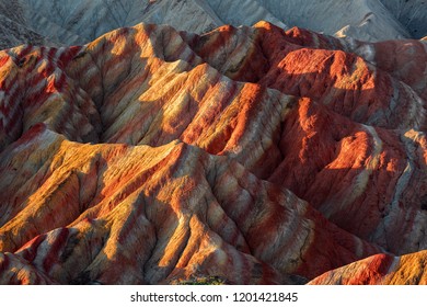 Zhangye Danxia National Geopark - Gansu Province, China. Chinese Danxia multicolor Danxia landform, rainbow hills, colored rocks, sandstone erosion, layers of Red, Yellow and Orange stripes. 张掖