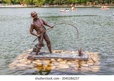 ZHELEZNOVODSK, RUSSIA - MAY 23, 2021: Photo of art object is the sculpture "The Fisherman and the Fisher Cat". Park lake.