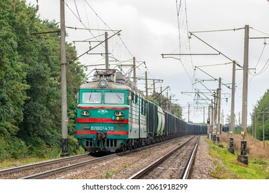 Zhmerynka, Ukraine - Autumn 2021: A powerful VL80 locomotive pulls a long train loaded with grain and corn into the seaport.  Railway transportation of grain.  Ukrainian railway