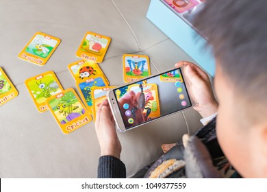 Zhongshan,China-December 30, 2017:kid Playing Augmented Reality Popup Of Scorpion Via Mobile. AR And VR Games Become More And More Popular.