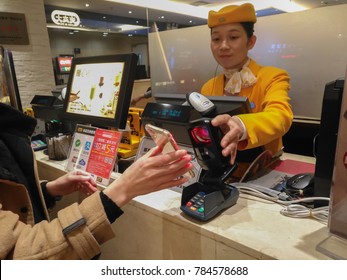 Zhongshan,China-January 1, 2018:girl doing payment at a restaurant via mobile.Wechat or Alipay for payment and money transfering via mobile becomes very common and popular in China,fast and safe.