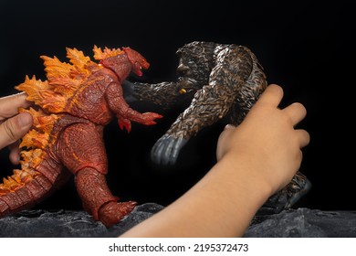 Zhongshan;China-May 7, 2021:kid Playing With Red Godzilla And King Kong At Home.