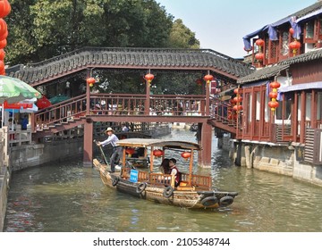 Zhouzhuang, China - March 28, 2009: Oarsman Poling A Boat In A Canal