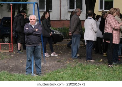 Zhytomyr, Ukraine - October 10, 2020: Portrait of elderly man standing in house yard. Concept of old age, life in soviet town