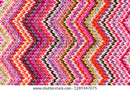 Zig Zag abstract textured background of close detail of multicolored woven material