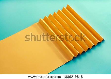 Zig Zag fold paper texture background, Yellow Zigzag paper with blue paper pattern paper background                           