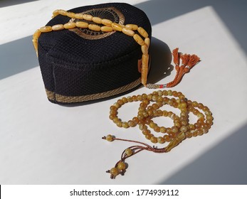 Zikr or prayer beads on string and men's prayer hat for muslim