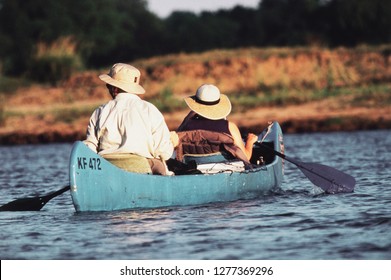 Zimbabwe, Mana Pools, Couple Canoeing At Zambezi River