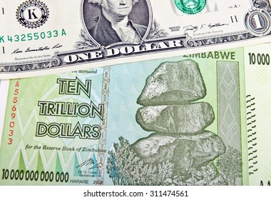 Zimbabwe Ten Trillion Dollars Bill And One American Dollar. Inflation Concept