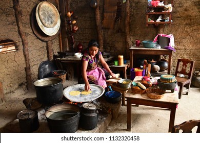 Zinacantan; United Mexican States - May 15 2018 : A Woman Is Cooking Tortillas In An Indian Kitchen