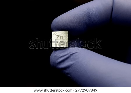 Zinc Element Cube in Gloved Hand