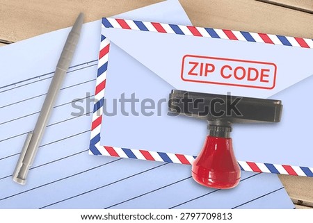 Zip code stamp on airmail envelope with rubber stamp, pen and lined letter paper.