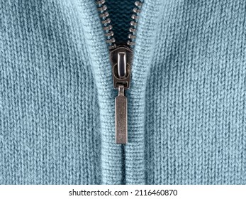 Zip fastener of cashmere sweater macro. Fashionable blue jacket with zipper fastening for cold season. Half-zip jumper or pullover of fine soft wool jersey close-up. Casual stylish clothes. Front view