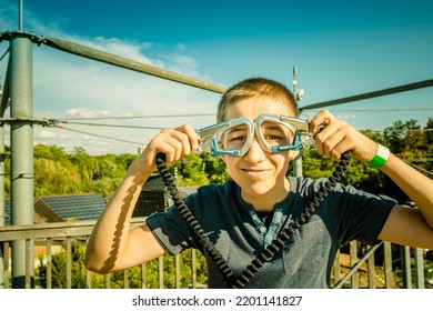 Zipline Equipment For Safety,  Adventure In  High Ropes Course.  Happy Boy Reached Highest Platform.