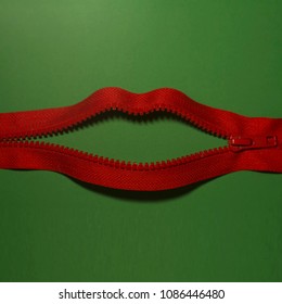 Zipped lips on the green background, abstract picture