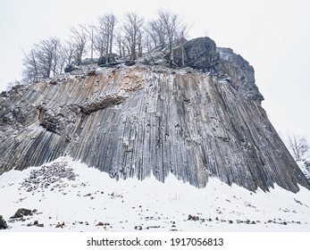 Zlaty vrch, rock formation of pentagonal and hexagonal basalt columns. Covered by snow and ice in winter time. - Shutterstock ID 1917056813