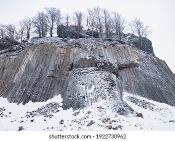 Zlaty vrch, rock formation of pentagonal and hexagonal basalt columns. Covered by snow and ice in winter time. - Shutterstock ID 1922730962