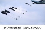 ZM401 RAF Royal Air Force Airbus C.1 A400M Atlas military cargo plane on a low-level cargo parachute drop exercise, blue sky light cloud