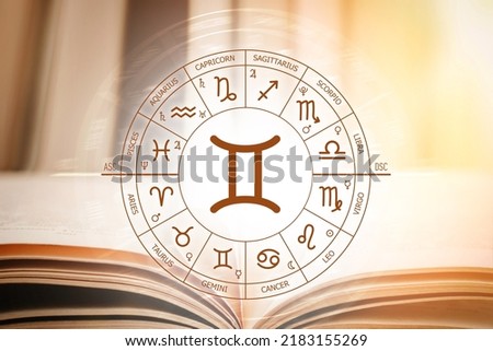 Zodiac circle against the background of an open book with gemini sign. Astrological forecast for the signs of the zodiac. Characteristics of the sign gemini. Astrology, esotericism, secret science
