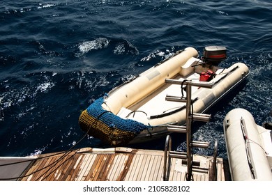 Zodiac fast boat (inflatable boat) sailing behind a diving boat in the sea