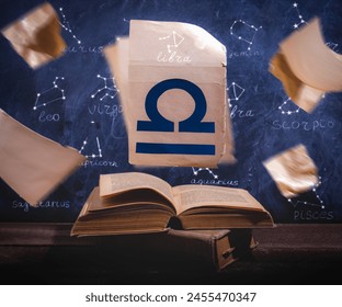 Zodiac sign Libra on old paper flying above old astrology books. - Powered by Shutterstock