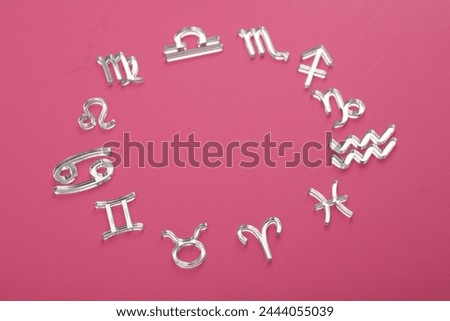 Zodiac signs on pink background, above view. Space for text