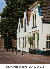 ZOETERMEER, NETHERLANDS - Aug 20, 2021: A vertical shot of three stylish houses on the Dorp Street in Zoetermeer, Netherlands