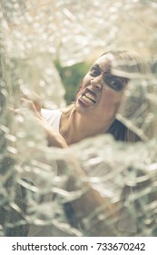 Zombie attacking through a broken window