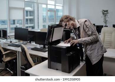 Zombie Businessman Standing By Xerox Machine And Copying Documents In Office