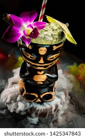 Zombie Cocktail Served In A Tiki Mug With Dry Ice