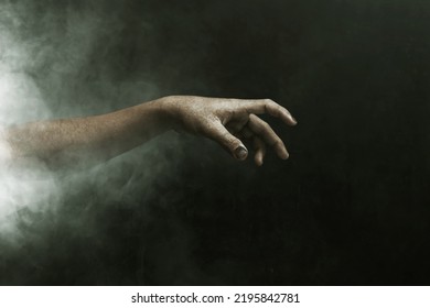 Zombie hand on dark background - Shutterstock ID 2195842781