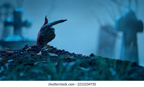 Zombie Hand Pointing To Something Out Of Grave. Holiday Event Halloween Concept