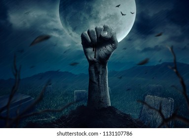 Zombie hands rising in dark Halloween night.