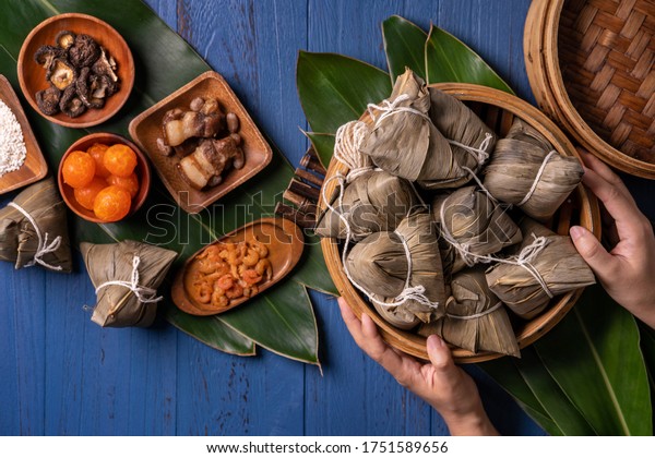 zongzi - Dragon Boat Festival concept
Rice dumpling, traditional Chinese food on blue wooden background
for Duanwu Festival, top view, flat lay design
concept.