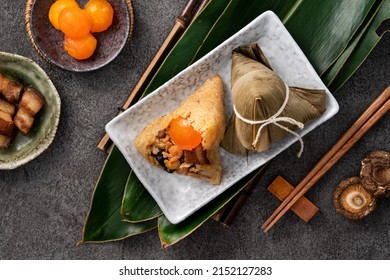 Zongzi, rice dumpling for Chinese traditional Dragon Boat Festival (Duanwu Festival) on dark gray table background with ingredient. - Shutterstock ID 2152127283