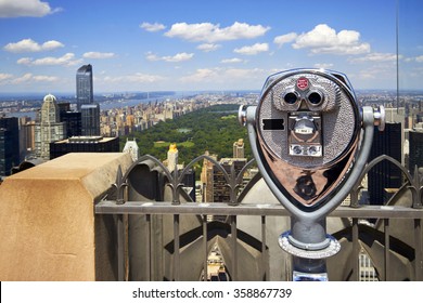 Zoom binoculars on Rockefeller Center with view on a Manhattan Central Park in NYC