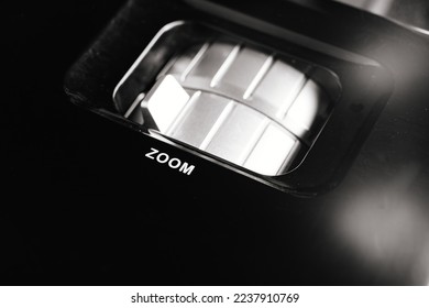 zoom control panel of Black Universal Projector. A video projector, an image projector, receives a video signal and projects onto the screen using a lens system.