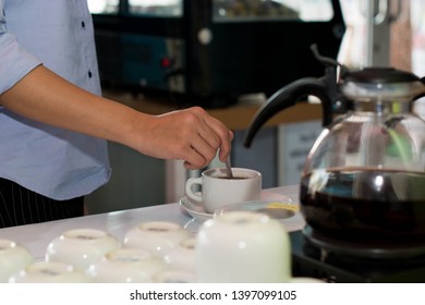 Zoom Of Female Hand Stir Cup Of Coffee At Cake Store