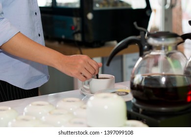 Zoom Of Female Hand Stir Cup Of Coffee At Cake Store