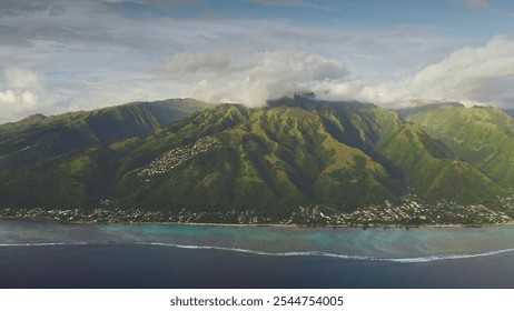 Zoom in panoramic flight to Tahiti island in south pacific ocean. Green mountains hills peaks under cloudy sky, turquoise water, vibrant coral reef and coastal village. Remote paradise, exotic travel - Powered by Shutterstock