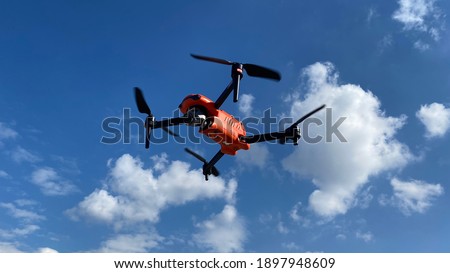 Zoom photo of latest technology RC camera drone or UAV (unmanned aerial vehicle) on a cloudy deep blue sky
