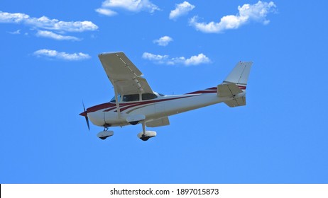 Zoom photo of small propeller airplane landing to small airport - Powered by Shutterstock