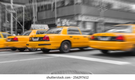 Zoomed And Blurred View Of New York Yellow Cabs Isolated On Black And White Background.