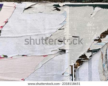 Zoomed close up texture of torn removed tattered street poster placard layers 