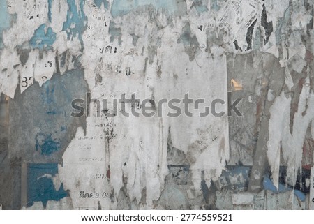 Zoomed close up texture of torn removed tattered street poster placard layers