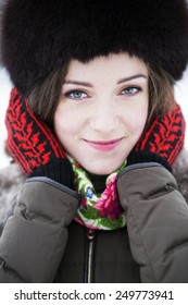 Zoomed Portrait Of A Female In Colored Mittens